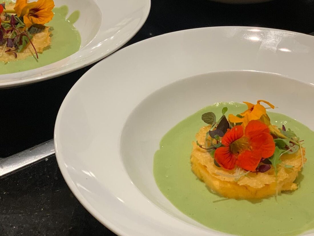 Crisp fritters in a chilled herb soup, crowned with nasturtium flowers and micro herbs