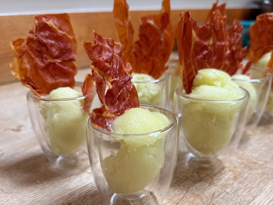 Melon sorbet in little double-walled glasses, each topped with a shard of crisped cured ham